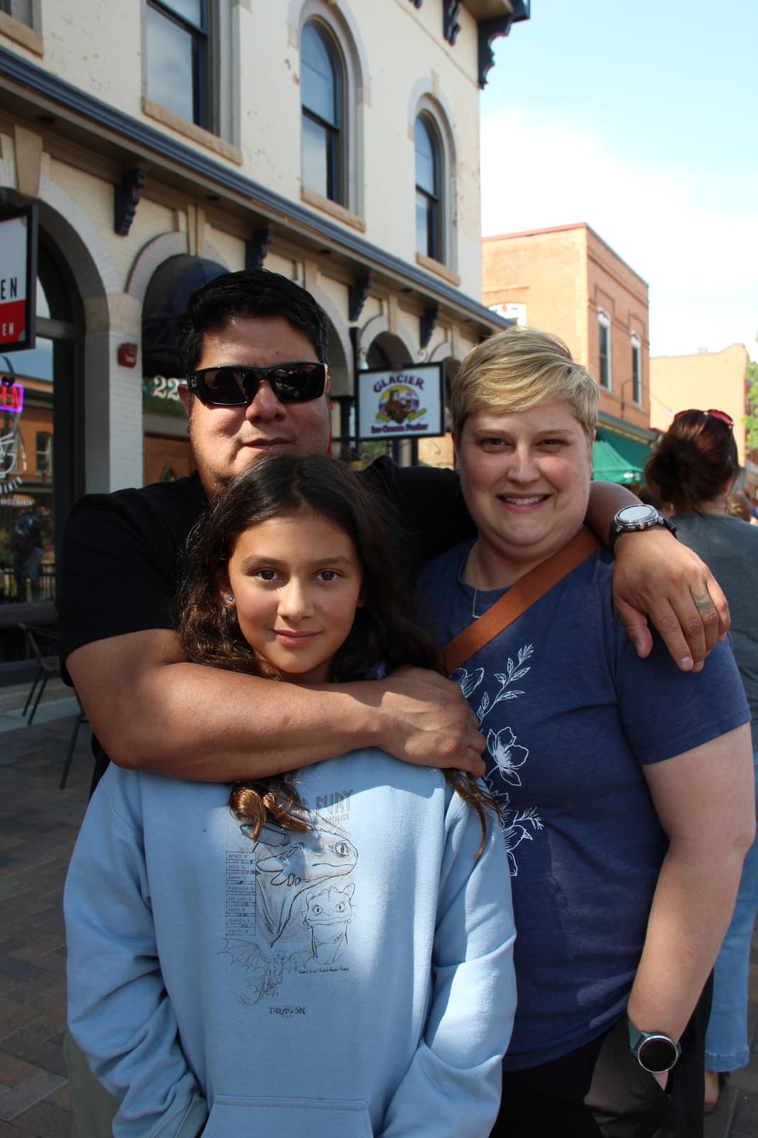 A family hug on the patio during opening day