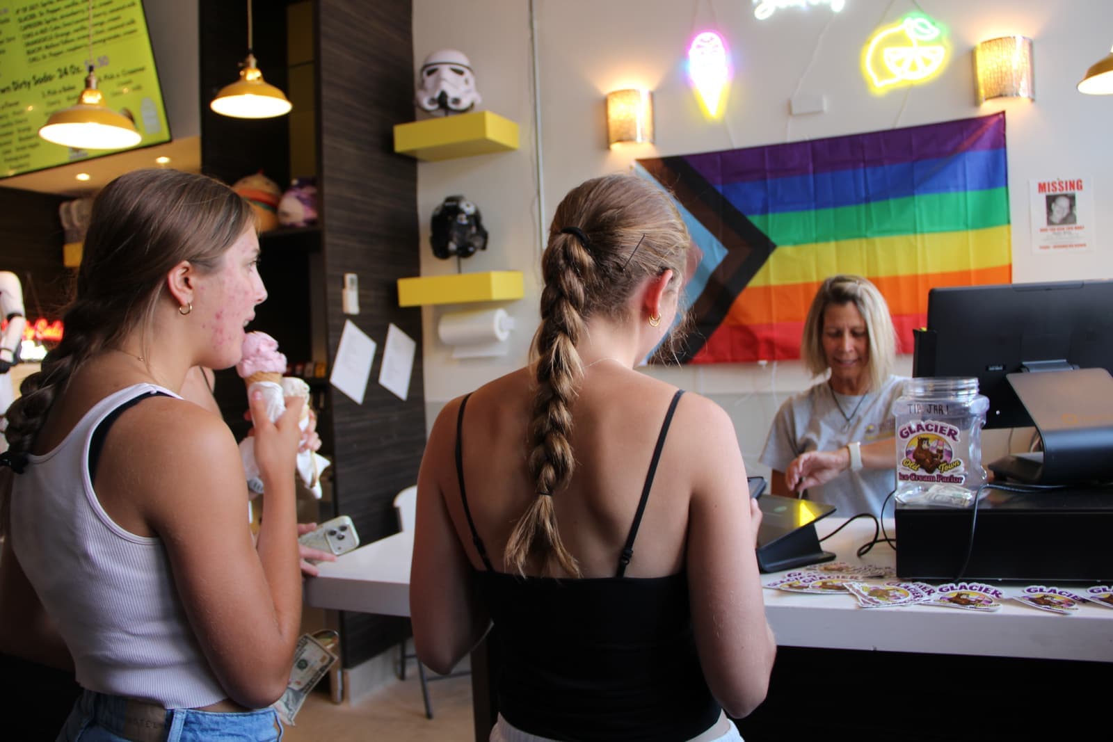 Crew running the sticker and merch table by the window