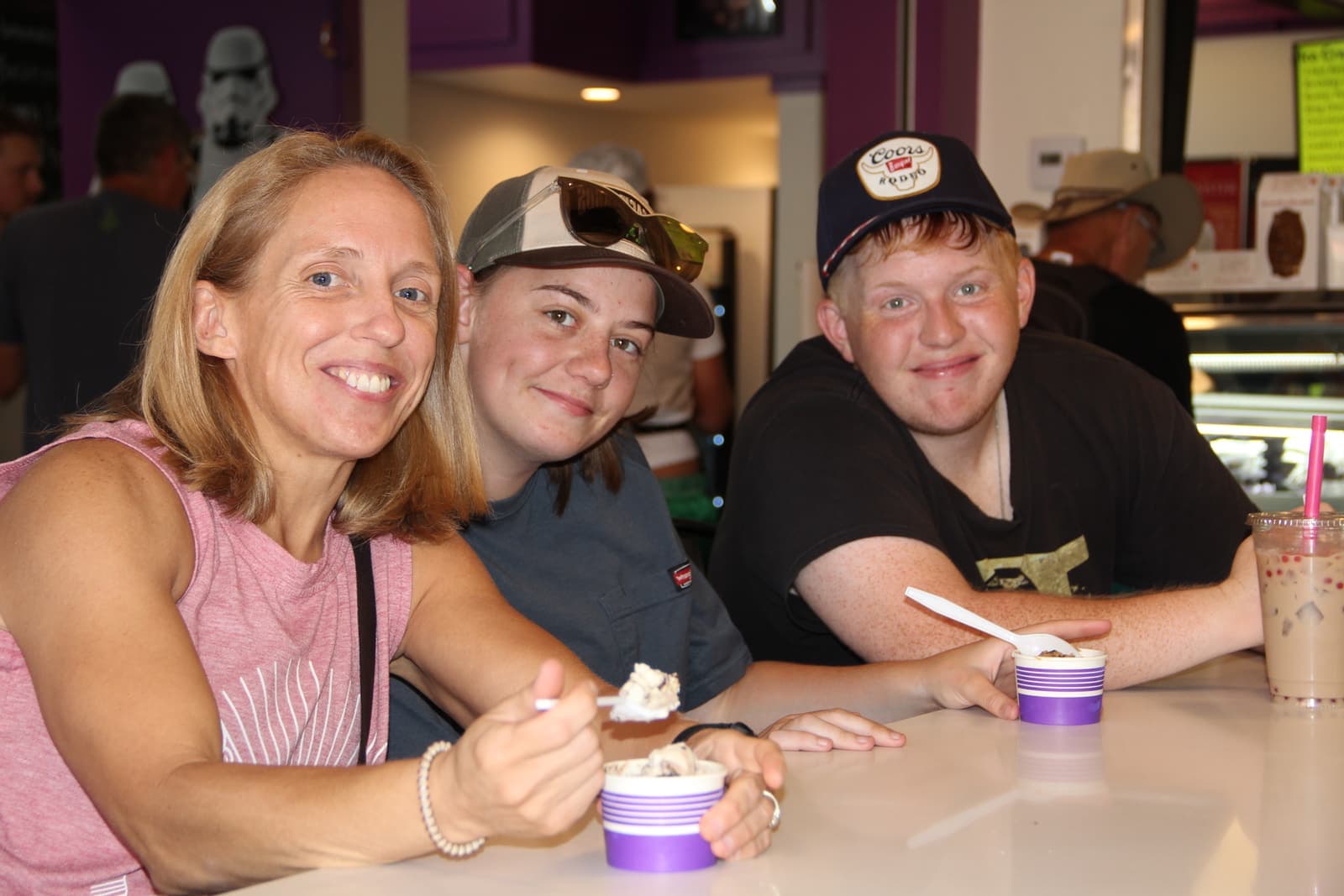 A family enjoying sundaes and shakes at the counter