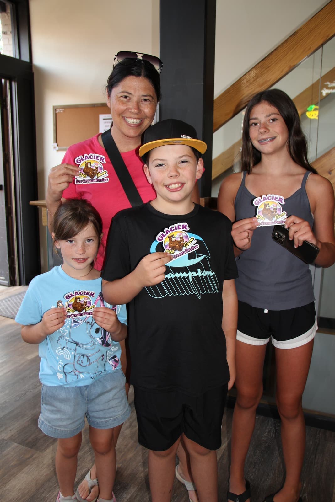 A family showing off their Glacier cards and cones